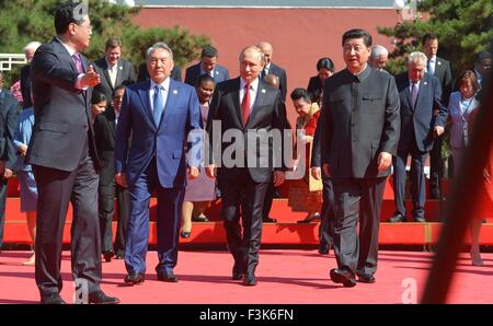 Russian President Vladimir Putin, center, and Chinese President Xi Jinping, right, walk with Kazakhstan's President Nursultan Nazarbayev ahead of a parade commemorating the 70th anniversary of Japanese surrender during World War II in front of Tiananmen Gate September 3, 2015 in Beijing, China. Stock Photo