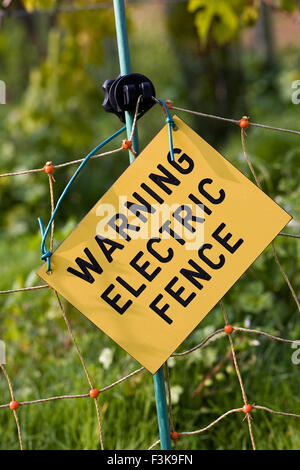 Electric fence warning sign. Stock Photo