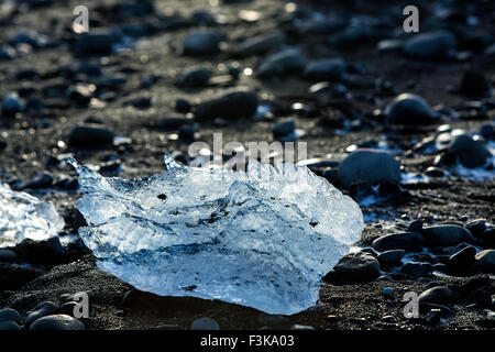 Ice blocks on black sand beach at glacier lagoon Jokulsarlon in Iceland, wintertime Stock Photo
