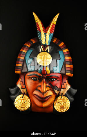 Indian Mayan Aztec ceramic mask with feather isolated on black paper background Stock Photo