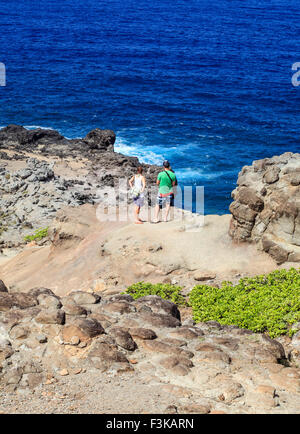 Hikers on the rugged trail to the Nakalele Blowhole on Maui Stock Photo