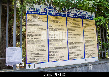 A board on display by the entrance instructing a number of rules in Italian, English, German, Spannish and Russian languages. Stock Photo
