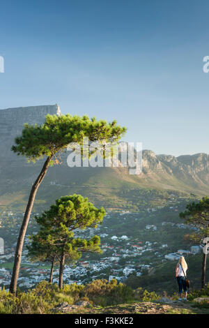 Woman looks at Table Mountain and Cape Town from Lion's Head on Signal Hill, Cape Town, South Africa Stock Photo