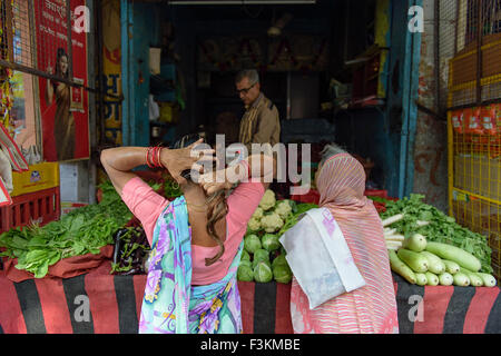 Unidentified local women buying a vegetables from street vendor in the street of Jodhpur. Stock Photo