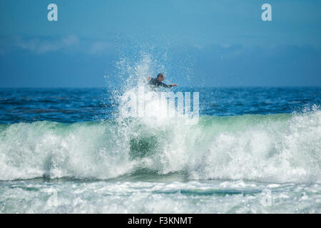 Male surfer rides the top of a wave in the Atlantic Ocean, Llandudno cove beach, Cape Town, South Africa Stock Photo