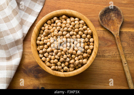 uncooked chickpeas in wooden bowl Stock Photo