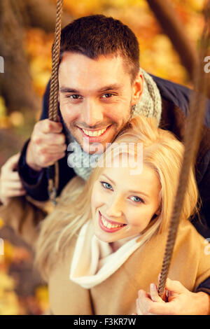 Romantic couple swing in the autumn park Stock Photo - Alamy