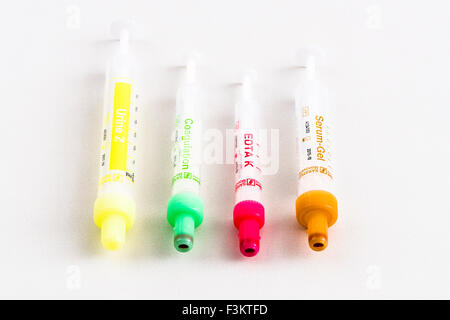 Four different pharmaceutical phials for medical use, displayed on a white table Stock Photo