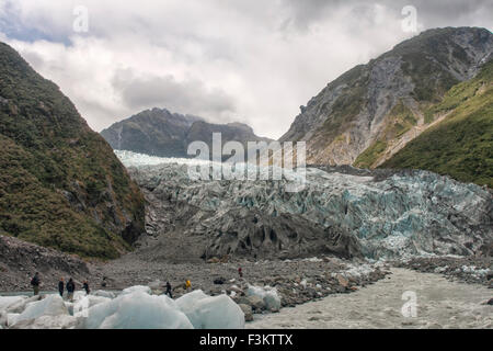 Hikers after a hike on the Franz Joseph Glacier in New Zealand Stock Photo