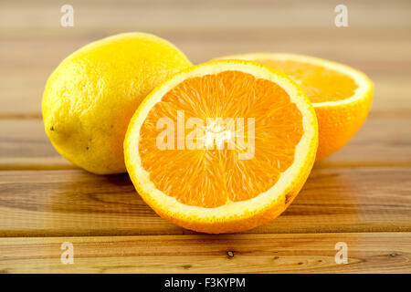 Sliced oranges with vibrant yellow lemon Stock Photo