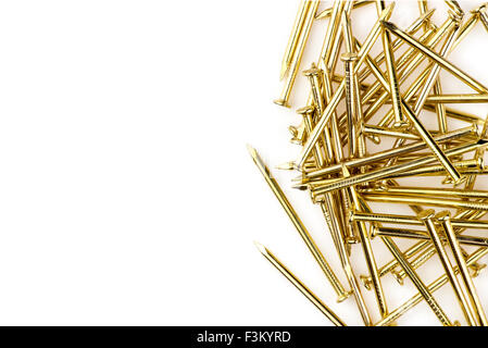 Macro of shiny brass nails isolated on white with copyspace Stock Photo