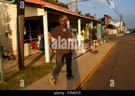 Skaters in Hawi. Hawi is the most northern town. Wooden houses painted in bold colors transform you into an atmosphere of the se Stock Photo