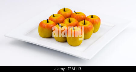 Mini apple shaped Indian barfi sweets made out of almond and milk powder Stock Photo