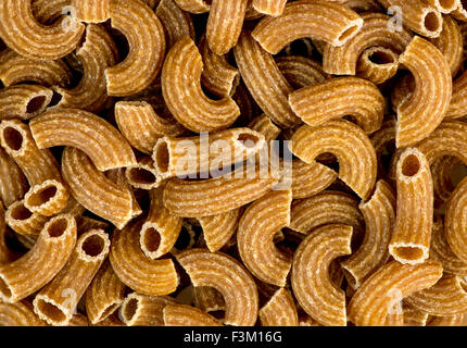 Macro background texture of wholemeal ribbed uncooked raw macaroni Stock Photo