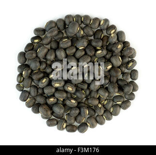 Black urad dal lentil beans in a bile isolated against white Stock Photo