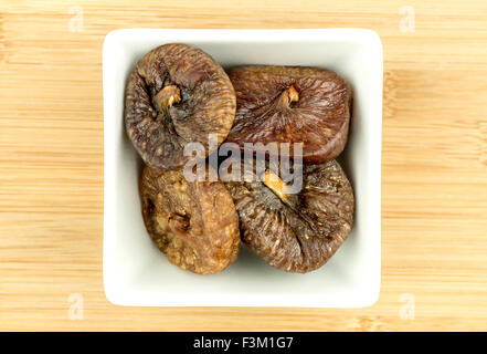 Dried figs in white bowl Stock Photo