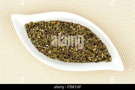 Dehydrated and dried basil leaves chopped in gourmet dish Stock Photo