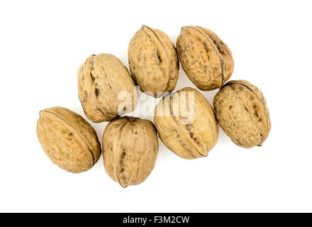 Pile of walnuts in shells isolated on white Stock Photo