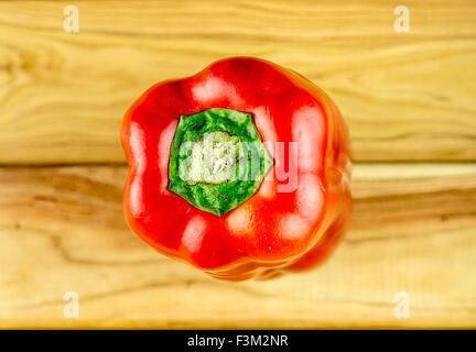 Aerial macro of juicy red pepper on chopping board Stock Photo