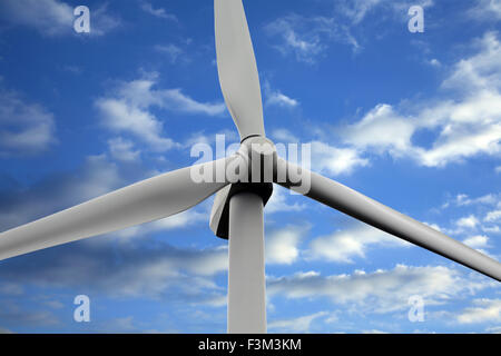 Close up of wind turbine against blue sky and clouds. Stock Photo