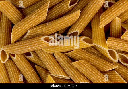 Macro closeup background texture of whole wheat rigatoni pasta Stock Photo