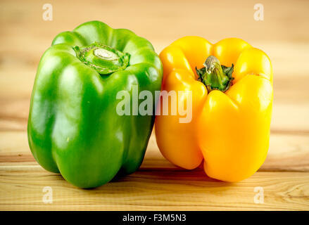 Organic ripe green and yellow capsicum peppers Stock Photo