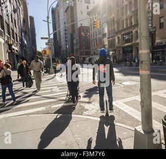 A unicyclist travels down Fifth Avenue in New York on his motorized segway-type unicycle onTuesday, October 6, 2015. (© Richard B. Levine) Stock Photo