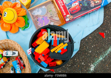 Assorted Items in close up flea market items spread on blanket/pavement Stock Photo