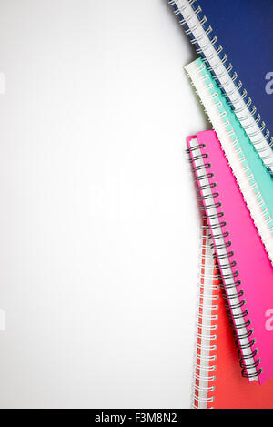 A few stacked notebooks isolated on white background Stock Photo
