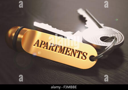 Keys with Word Apartments on Golden Label. Stock Photo