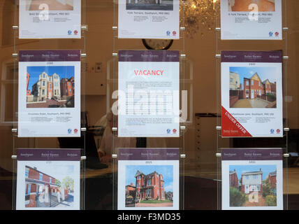 Property for Sale A man looking into a estate agent shop window to view properties for sale, Liverpool, Merseyside, UK Stock Photo