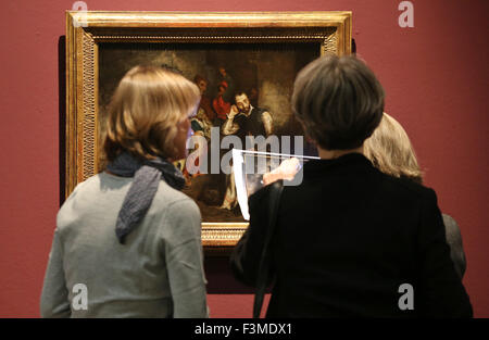 Leipzig, Germany. 9th Oct, 2015. Museum workers check a painting 'Tasso im Irrenhaus' by Eugene Delacroix in the Museum der bildenen Kuenste in Leipzig, Germany, 9 October 2015. The exhibition 'Eugene Delacroix and Paul Delaroche. History as Sensation' features the work of both 19th century French painters from 11 October 2015 to 17 January 2016. Photo: JAN WOITAS/dpa/Alamy Live News Stock Photo