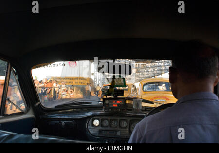 Inside a Yellow Ambassador taxi (cab) crossing Howrah Bridge in Kokata (Calcutta), India. Kolkata, West Bengal, India. Kolkata, Stock Photo