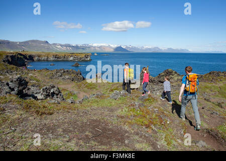 Family hiking the Hellnar-Arnarstapi coastal path, Snaefellsnes Peninsula, Vesturland, Iceland.