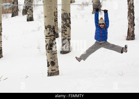 A girl riding a zipline, Telluride, Colorado. Stock Photo