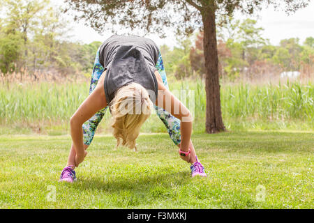 Woman in standing straddle yoga pose Stock Photo