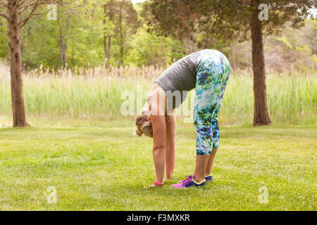 Woman in Forward Fold Stock Photo
