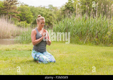 Woman in prayer meditation pose Stock Photo