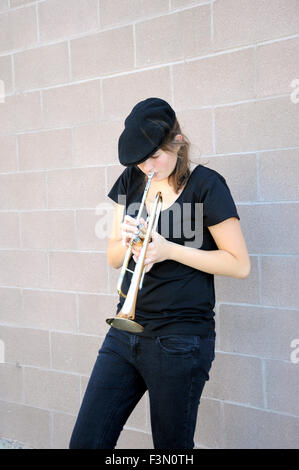 Female trumpet player blowing her horn. Stock Photo