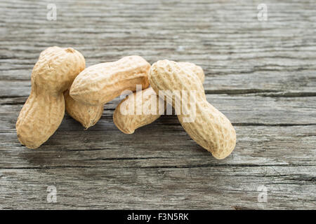 Peanuts in a shell on a rustic wooden board Stock Photo