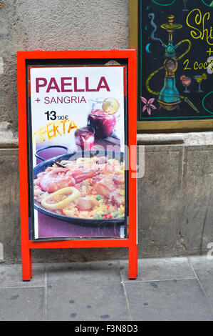 Street billboard advertising restaurant selling paella & sangria in Barcelona Catalonia Spain ES Stock Photo