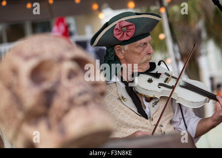 Tybee Island, Georgia, USA. 09th Oct, 2015. A musician dressed in pirate costume plays the fiddle at the annual three-day Tybee Island Pirate Festival October 9, 2015 in Tybee Island, Georgia. Stock Photo