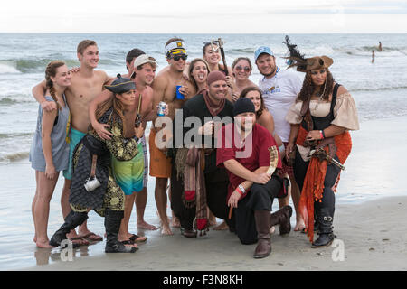 Tybee Island, Georgia, USA. 09th Oct, 2015. A group of pirates pose with tourists on the beach at the annual three-day Tybee Island Pirate Festival October 9, 2015 in Tybee Island, Georgia. Stock Photo