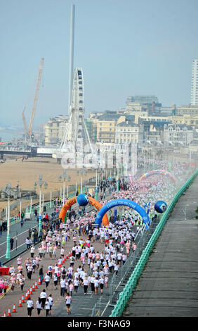Brighton Sussex UK Saturday 10th October 2015 - Thousands of people take part in the annual Color Run event on Brighton seafront today where they get covered in colourful powder as they run the 5k course . The run known as the 'Happy Run' is a celebration of health happiness individuality and giving back to the community Credit:  Simon Dack/Alamy Live News Stock Photo