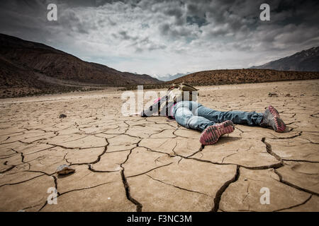 Traveller lays on the dried ground Stock Photo