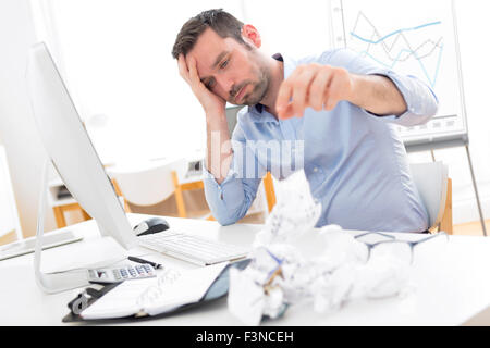View of a Young attractive man too tired to work Stock Photo