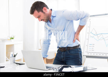 View of a Young attractive business got backache because of burn out Stock Photo