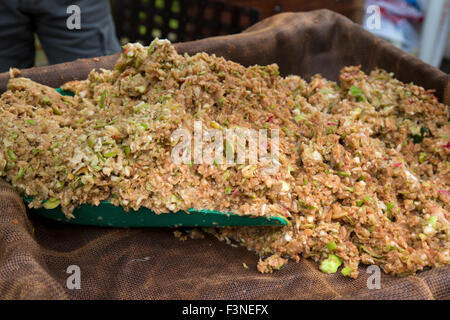Mulched apples being prepared for an apple press to make apple juice. Stock Photo