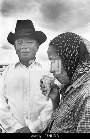 A navajo husband smiles while his wife sips a sno-cone during a day in town in Gallup, New Mexico Stock Photo