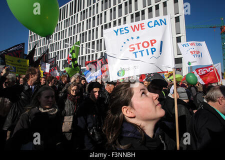 Berlin, Germany. 10th Oct, 2015. People hold flags and balloons and shout slogans during a protest in Berlin, Germany, on Oct. 10, 2015. Thousands of people protested in Berlin on Saturday against a free trade deal under negotiations between the United States and the European Union (EU). The United States and the EU started talks on the deal, known as the Transatlantic Trade and Investment Partnership (TTIP), in 2013. Once completed, it will create the largest free trade zone, covering nearly half of world's gross domestic product (GDP). Credit:  Zhang Fan/Xinhua/Alamy Live News Stock Photo
